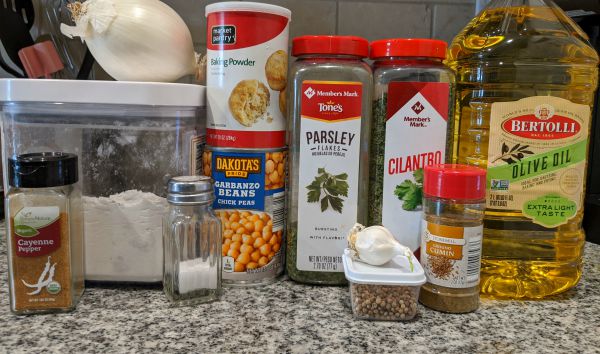 Falafel Ingredients - Cayenne Pepper, Onion, Flour, Salt, Baking Powder, Chickpeas, Parsley, Cilantro, Garlic, Coriander, Cumin, Olive Oil